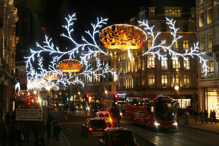 London, UK - November 21, 2013: Christmas Lights Display on Regent Street in London, people present. The modern colourful Christmas lights attract and encourage people to the street. 
のeditorial素材