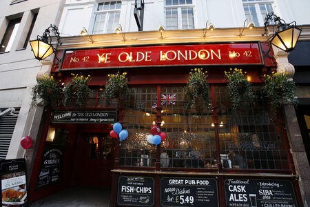 London, UK - March 07, 2014: Outside view of a public house, people present, known as pub, for drinking and socializing, is the focal point of the community, Pub business, now about 53,500 pubs in the UK, has been declining every year.
のeditorial素材