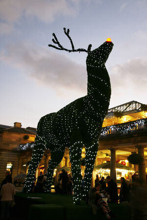 London, UK - December 9, 2013: Christmas Lights Display in Covent Garden Market, people prsent, in London. The modern colourful Christmas lights attract and encourage people to the market. 
のeditorial素材