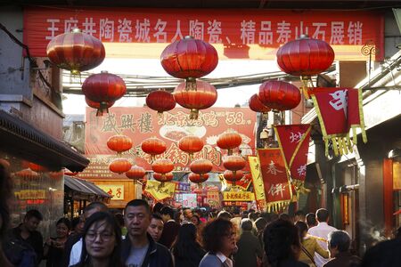 London, UK - Oct 15, 2014:  Street view of Dazhalan Market, crowd present. This is the famous business street outside Qianmen, one of the largest traditional market in Beijing.のeditorial素材
