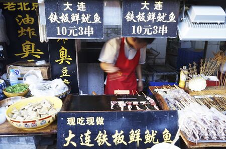London, UK - Oct 15, 2014:  Street view of Dazhalan Market, food stall present, on Oct 15, 2014, Beijing, China. This is famous business street outside Qianmen, one of the largest traditional market in Beijing.のeditorial素材