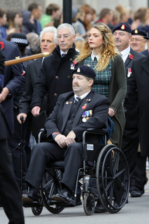 London, UK - November 8, 2015: People take part in Remembrance Day, Poppy Day or Armistice Day, nearst Sunday of 11 every Nov, observed by Commonwealth of Nations, to remember armed forces who have died since First World War.のeditorial素材