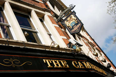 London, UK - April 15, 2012: English pub sign, Public house, known as pub, is focal point of...