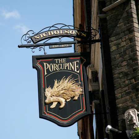 London, UK - April 30, 2012: English pub sign. Public house, known as pub, for drinking and socializing, is the focal point of the community. Pub business, now about 53,500 pubs in the UK, has been declining every year.のeditorial素材