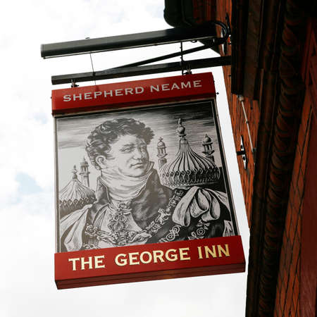London, UK - May 16, 2012: English pub sign. Public house, known as pub, for drinking and socializing, is the focal point of the community. Pub business, now about 53,500 pubs in the UK, has been declining every year.のeditorial素材