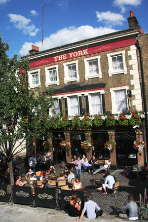 London, UK - July 21, 2010: Outside view of pub, for drinking and socializing, focal point of community. Pub business, now about 53,500 pubs in the UK, has been declining every year.のeditorial素材