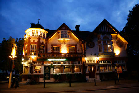 London, UK - May 16, 2012: Outside view of pub, for drinking and socializing, focal point of community. Pub business, now about 53,500 pubs in the UK, has been declining every year.のeditorial素材