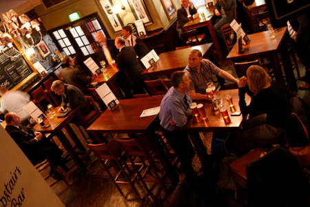 London, UK - April 30, 2012: Inside view of a public house, known as pub, for drinking and socializing, is the focal point of the community, Pub business has been declining every year.のeditorial素材