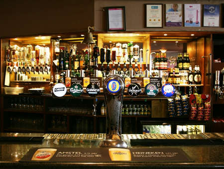London, UK - March 07, 2011: Inside view of a public house, known as pub, for drinking and socializing, is the focal point of the community, Pub business has been declining every year.のeditorial素材