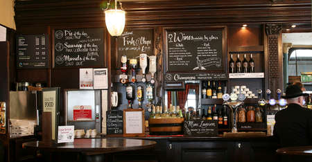 London, UK - August 03, 2010: Inside view of a public house, known as pub, for drinking and socializing, is the focal point of the community, Pub business has been declining every year.のeditorial素材