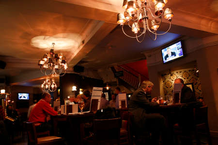 London, UK - April 30, 2012: Inside view of a public house, known as pub, for drinking and socializing, is the focal point of the community, Pub business has been declining every year.のeditorial素材