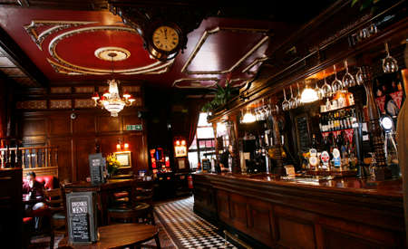 London, UK - May 5, 2012: Inside view of a public house, known as pub, for drinking and socializing, is the focal point of the community, Pub business has been declining every year.のeditorial素材