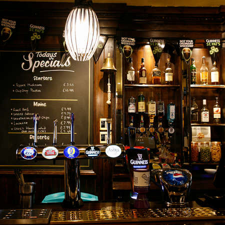London, UK - March 14, 2014: Inside view of a public house, known as pub, for drinking and socializing, is the focal point of the community, Pub business has been declining every year.のeditorial素材