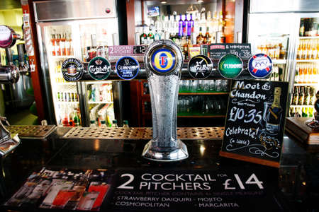 London, UK - April 22, 2012: Inside view of a public house, known as pub, for drinking and socializing, is the focal point of the community, Pub business has been declining every year.のeditorial素材