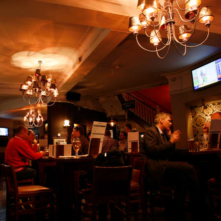 London, UK - April 30, 2012: Inside view of a public house, known as pub, for drinking and socializing, is the focal point of the community, Pub business has been declining every year.のeditorial素材