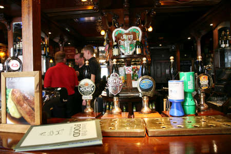 London, UK - August 30, 2010: Inside view of a public house, known as pub, for drinking and socializing, is the focal point of the community, Pub business has been declining every year.のeditorial素材