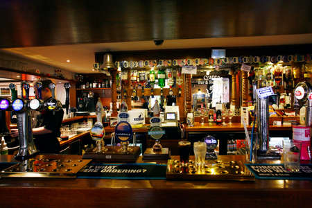 London, UK - September 23, 2013: Inside view of a public house, known as pub, for drinking and socializing, is the focal point of the community, Pub business has been declining every year.のeditorial素材