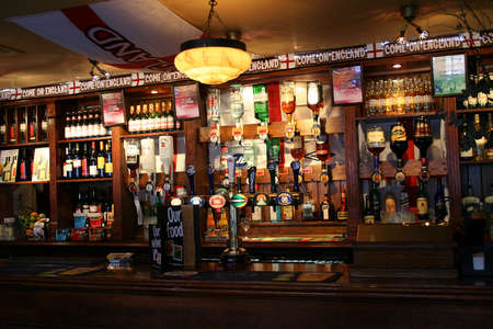 London, UK - April 12, 2006: Inside view of a public house, known as pub, for drinking and socializing, is the focal point of the community, Pub business has been declining every year.のeditorial素材