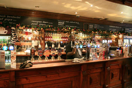 London, UK - December 01, 2010: Inside view of a public house, known as pub, for drinking and socializing, is the focal point of the community, Pub business has been declining every year.のeditorial素材