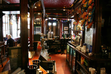 London, UK - August 30, 2010: Inside view of a public house, known as pub, for drinking and socializing, is the focal point of the community, Pub business has been declining every year.のeditorial素材