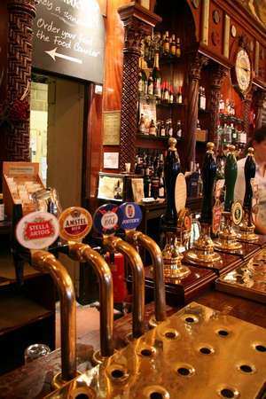 London, UK - June 03, 2006: Inside view of a public house, known as pub, for drinking and socializing, is the focal point of the community, Pub business has been declining every year.のeditorial素材