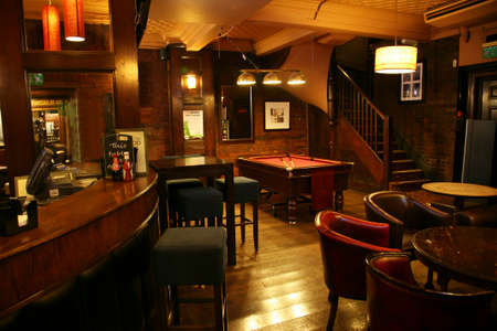 London, UK - August 30, 2010: Inside view of a public house, known as pub, for drinking and socializing, is the focal point of the community, Pub business has been declining every year.のeditorial素材