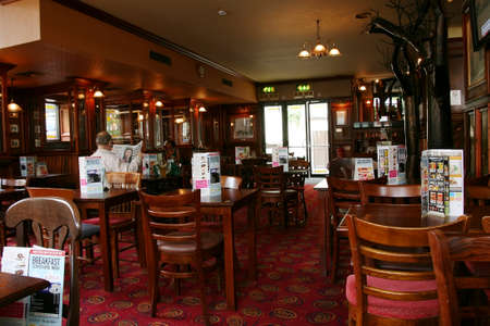 London, UK - August 26, 2010: Inside view of a public house, known as pub, for drinking and socializing, is the focal point of the community, Pub business has been declining every year.のeditorial素材