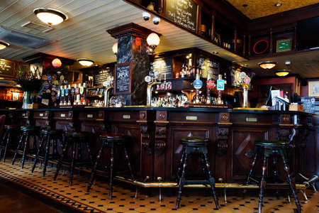 LONDON - April 26: Interior of pub, for drinking and socializing, focal point of the community, on April 26, 2017, London, UK. Pub business, now about 53,500 pubs in UK, has been declining every year.のeditorial素材
