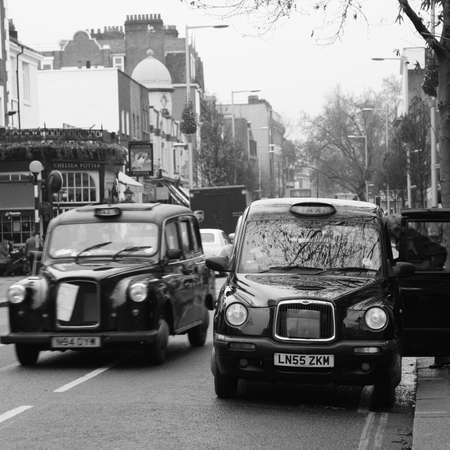 London, UK - October 29, 2010: Taxi in the street of London. Cabs are the most iconic symbol of London as well as London's Red Double Decker Bus.のeditorial素材