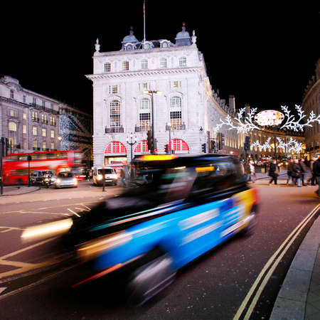 London, UK - December 3, 2012: London Taxi, also called hackney carriage, black cab, in Piccadilly Circus, London. Traditionally Taxi cabs are all black in London but now produced in various colors.のeditorial素材