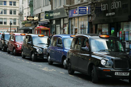London, UK - August 17, 2010: Taxis in the street of London. Cabs are the most iconic symbol of London as well as London's Red Double Decker Bus.のeditorial素材