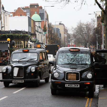 London, UK - October 29, 2010: Taxi in the street of London. Cabs are the most iconic symbol of London as well as London's Red Double Decker Bus.のeditorial素材