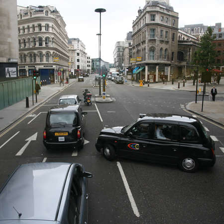 Lonodn, UK - August 19, 2010 : Taxi in the street of London on May 8, 2010 in London, UK. Cabs, Taxis, are the most iconic symbol of London as well as London's Red Double Decker Bus.のeditorial素材