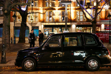London, UK - November 30, 2011 : Taxi in the street of London. UK. Cabs, Taxis, are the most iconic symbol of London as well as London's Red Double Decker Bus.のeditorial素材