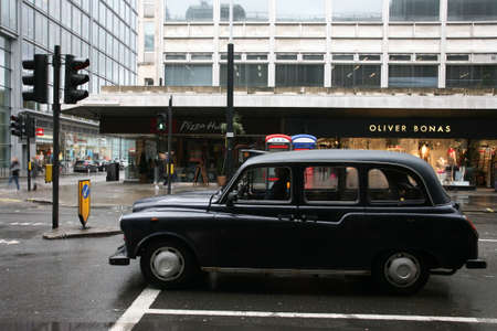 London, UK - February 26, 2011: Taxi in the street of London. Black cabs are the most iconic symbol of London as well as London's Red Double Decker Bus.のeditorial素材