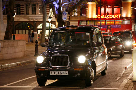 London, UK - November 30, 2011 : Taxi in the street of London. UK. Cabs, Taxis, are the most iconic symbol of London as well as London's Red Double Decker Bus.のeditorial素材