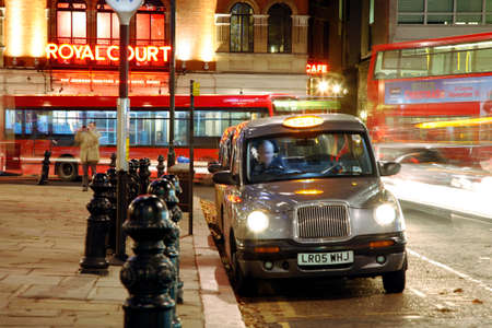 London, UK - November 30, 2011 : Taxi in the street of London. UK. Cabs, Taxis, are the most iconic symbol of London as well as London's Red Double Decker Bus.のeditorial素材