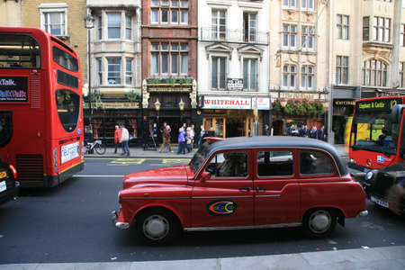 London, UK - November 04, 2010: Taxi in the street of London. Cabs are the most iconic symbol of London as well as London's Red Double Decker Bus.のeditorial素材