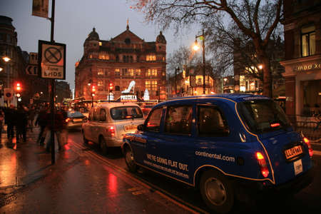 London, UK - December 30, 2010: Taxi in the street of London. Cabs are the most iconic symbol of London as well as London's Red Double Decker Bus.のeditorial素材