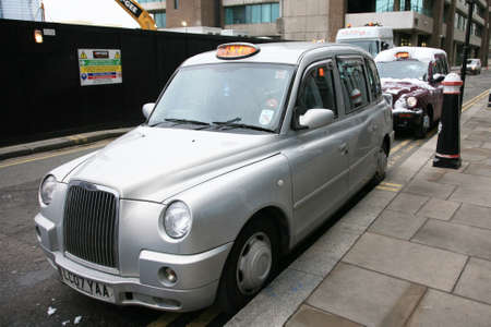 Lonodn, UK - December 1, 2010 : Taxi in the street of London on May 8, 2010 in London, UK. Cabs, Taxis, are the most iconic symbol of London as well as London's Red Double Decker Bus.のeditorial素材