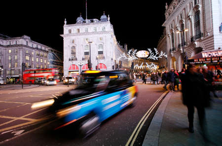 London, UK - December 3, 2012: London Taxi, also called hackney carriage, black cab, in Piccadilly Circus, London. Traditionally Taxi cabs are all black in London but now produced in various colors.のeditorial素材