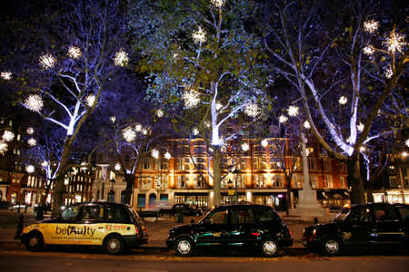 London, UK - November 30, 2011: Christmas Lights Display on Sloane Square in Chelsea, London. The modern colourful Christmas lights attract and encourage people to the street.のeditorial素材