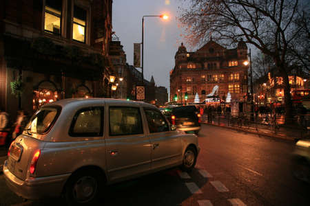 London, UK - December 30, 2010: Taxi in the street of London. Cabs are the most iconic symbol of London as well as London's Red Double Decker Bus.のeditorial素材