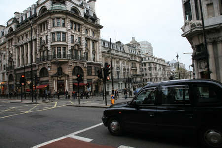 London, UK - November 13, 2010: Taxi in the street of London. Cabs are the most iconic symbol of London as well as London's Red Double Decker Bus.のeditorial素材