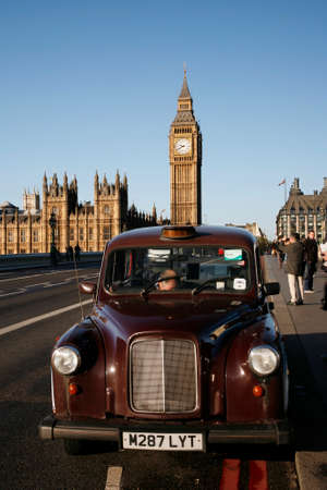 London, UK - October 27, 2012: London Taxi FX4, also called hackney carriage, black cab, Big Ben in the back ground. FX4 is manufactured by the London Taxis International, LTI.のeditorial素材