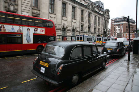 London, UK - February 26, 2011: Taxi in the street of London. Black cabs are the most iconic symbol of London as well as London's Red Double Decker Bus.のeditorial素材