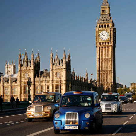 London, UK - October 27, 2012: London Taxis, also called hackney carriage, black cab, Big Ben in the back ground. Traditionally Taxi cabs are all black in London but now produced in various colors.のeditorial素材