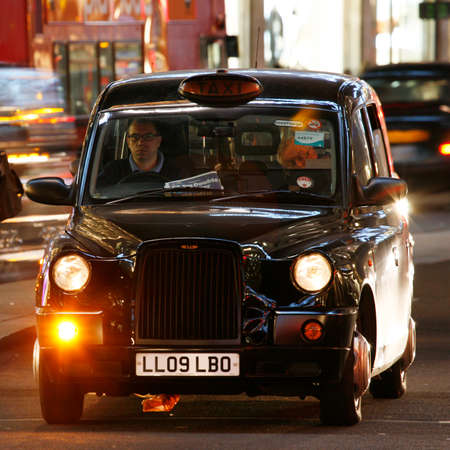 London, UK - December 4, 2013: London Taxi, TX4, also called hackney carriage, black cab. Traditionally Taxi cabs are all black in London but now produced in various colors. TX4 is manufactured by the London Taxis International, LTI.のeditorial素材