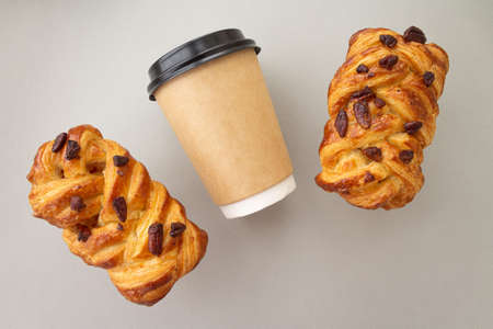 Coffee to go concept. Disposable craft cup with black plastic cover on a trendy grey background. Place for text. Flat lay style. Top viewの写真素材