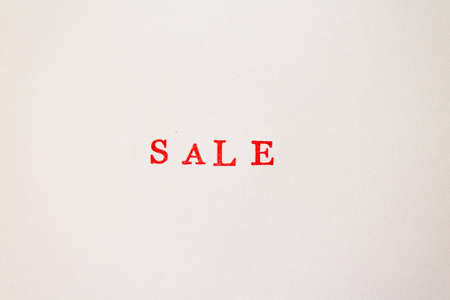 The red word sale stamped on a white paper. Price reduction and promotion in trade and services concept photo.の写真素材